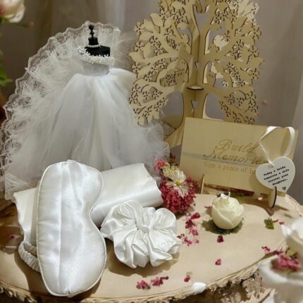 Elegifta Wedding Gift Set featuring an elegant mini wedding dress, sophisticated feather hand fan, beautiful guest book for memories, luxurious silk rose pillow cases, stylish hair tie, whimsical satan eye mask, serene white flower candle, meaningful wedding heart message, charming mini bouquet, and fragrant natural rose soap.