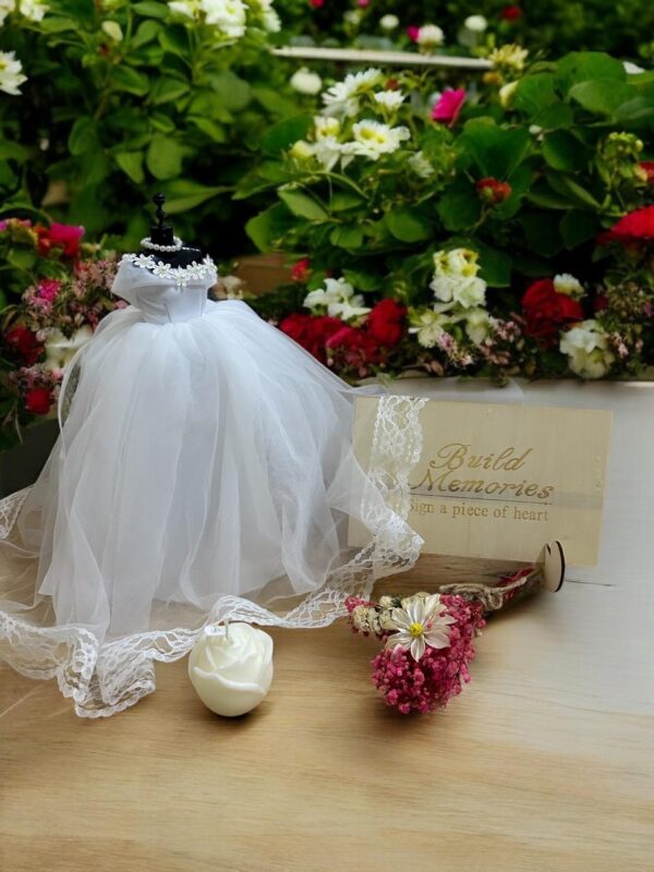 Elegifta Wedding Gift Set featuring an elegant mini wedding dress, sophisticated feather hand fan, beautiful guest book for memories, luxurious silk rose pillow cases, stylish hair tie, whimsical satan eye mask, serene white flower candle, meaningful wedding heart message, charming mini bouquet, and fragrant natural rose soap.