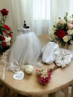 Elegifta Wedding Gift Set featuring an elegant mini wedding dress, sophisticated feather hand fan, beautiful guest book for memories, luxurious silk rose pillow cases, stylish hair tie, whimsical satan eye mask, serene white flower candle, meaningful wedding heart message, charming mini bouquet, and fragrant natural rose soap.